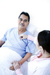 Doctor examining patient in a ward