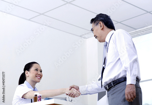 Photo: Two adults shaking hands Two adults shaking hands