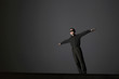 Businessman with his eyes being blindfolded spreading his hands