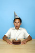 Boy blowing the candles on the birthday cake
