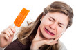 Photo: Woman with hypersensitive teeth eating ice lolly Woman with hypersensitive teeth eating ice lolly