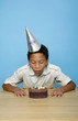 Boy blowing the candles on the birthday cake