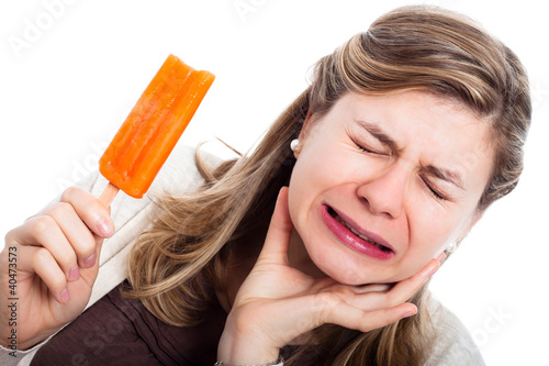 Photo: Woman with hypersensitive teeth eating ice lolly Woman with hypersensitive teeth eating ice lolly