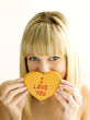 A young teen holding a cookie with both hands