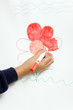 Girl colouring picture on drawing board