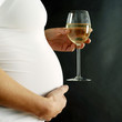 Pregnant woman holding a glass of wine