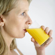 Woman drinking a glass of orange juice