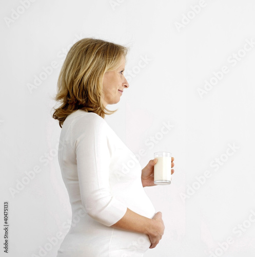 Photo: Pregnant woman with a glass of milk Pregnant woman with a glass of milk