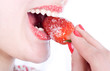 Woman eating a strawberry