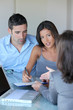 Couple in office signing contractual documents