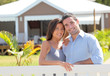 Couple standing in front of new home