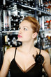 Woman looking at the selection of wine in the wine cellar
