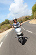 Young woman riding motorbike