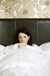 An ill woman in bed