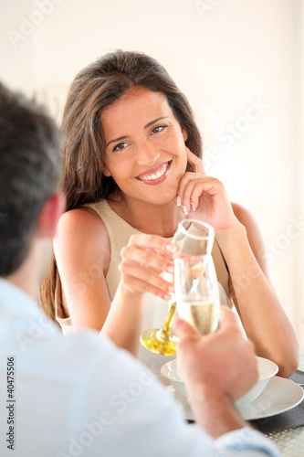 Photo: Woman cheering with glass of champaign in fancy restaurant Woman cheering with glass of champaign in fancy restaurant
