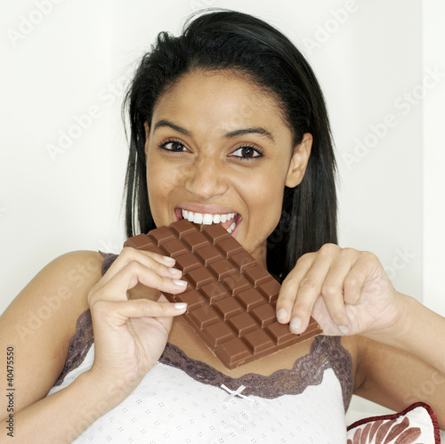 Photo: Woman enjoying a bar of chocolate Woman enjoying a bar of chocolate