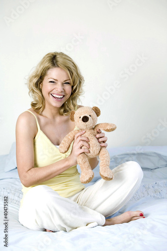 Photo: A woman holding a teddy bear A woman holding a teddy bear