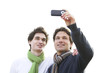 Two men taking photographs with mobile