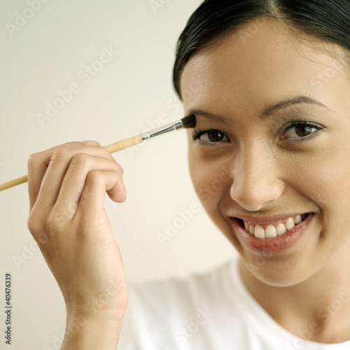 Photo: Woman applying eye shadow Woman applying eye shadow