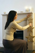Woman putting up a Christmas ornament