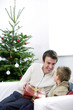 A father giving a Christmas present to his son