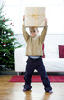Little boy lifting a present