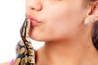 Teenage girl kissing small pet python