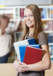 young student girl with book in library