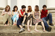 Group of Teenagers sitting on the stair, and speaking together