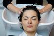 Beautiful woman getting a hair wash. In a hair salon