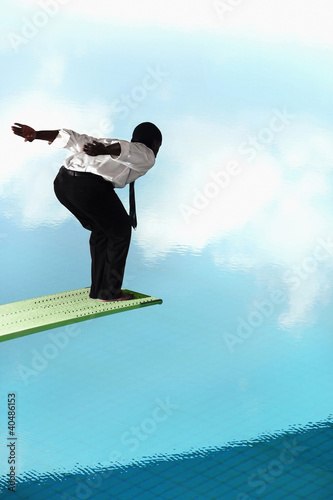 Photo: Businessman about to jump off the diving board Businessman about to jump off the diving board