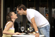 Man standing up and staring into woman's eyes