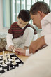 Man playing chess game with boy