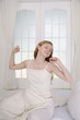 Woman stretching in bed
