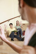 Man waving to his friends sitting on the stairs