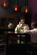 Businessmen having discussion over glasses of cocktails