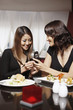 Woman showing her friend a text message