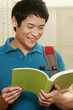 Man with backpack reading a book