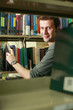 Man searching for a book in the library