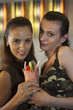 Women sharing a cocktail