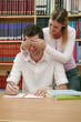 Woman covering man's eyes in the library