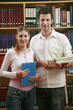 Man and woman posing in the library