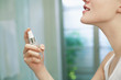 Woman applying perfume