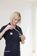Woman dripping liquid into test tube using pipette