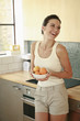Woman holding a bowl of oranges