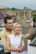 Man and taking photograph with a camera phone