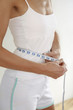 Woman measuring her waist