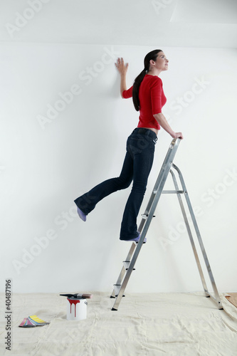 Photo: Woman standing on ladder Woman standing on ladder