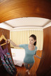 Woman choosing clothes from her wardrobe