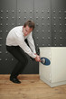 Businessman pulling handle on safe
